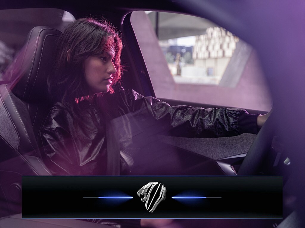 Woman driving the new PEUGEOT E-3008 SUV